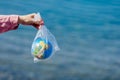 The Earth in a plastic bag. World Environment Day concept.