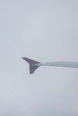 Earth in the porthole under the wing of an airplane. Flying in the fog above the clouds, nothing is visible Royalty Free Stock Photo