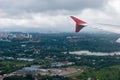 Earth in the porthole under the wing of an airplane. Flying in the fog over cities, rivers, forests Royalty Free Stock Photo