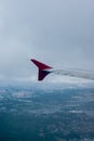 Earth in the porthole under the wing of an airplane. Flying in the fog over cities, rivers, forests Royalty Free Stock Photo