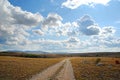 Earth road, blue sky and clouds Royalty Free Stock Photo