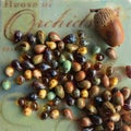 Earth tone glass beads teardrop on colorful background. Autumn inspired bead mix for jewelry making and crafts