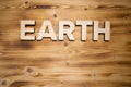 EARTH word made with building blocks on wooden board