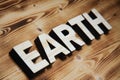 EARTH word made with building blocks on wooden board