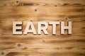 EARTH word made with building blocks on wooden board