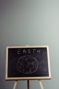 earth written on blackboard with earth symbol, background, high