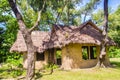 Earthen house under shade of trees. An earth house, also known as earth berm, earth sheltered home, or eco-house is an architectur Royalty Free Stock Photo