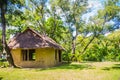Earthen house under shade of trees. An earth house, also known as earth berm, earth sheltered home, or eco-house is an architectur Royalty Free Stock Photo