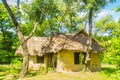 Earthen house under shade of trees. An earth house, also known as earth berm, earth sheltered home, or eco-house is an architectur Royalty Free Stock Photo