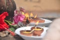 Earthen lamps in a temple with some flowers to worship lord Shiva