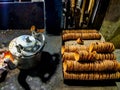 Earthen teapot and kettle in an indian roadside tea shop beside red smouldering coal burner
