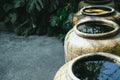 Earthen water jar in garden. rain pot reservoir