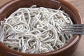 Earthenware bowl withyoung eels cooked with garlic Royalty Free Stock Photo