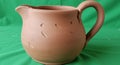 Earthenware jug with a rounded body and a large handle, crafted from terracotta clay. Royalty Free Stock Photo