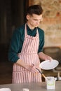 Earthenware in potter`s hand. Artist making ornament on ceramic product. Male potter working