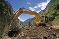 Earthmover bulldozer in himalayas clearing landslide Royalty Free Stock Photo