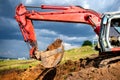 Earthmover, industrial digger and excavator working in sandpit