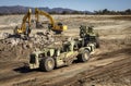 Earthmoving equipment on a construction site with shovel cranes in the background Royalty Free Stock Photo
