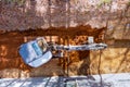 An earthmoving worker digging the ground at a construction site with a crawler excavator bucket used for earthmoving Royalty Free Stock Photo