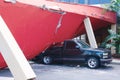 Earthquake damaged building crushed truck vehicle