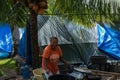 Earthquake victim washing outside in camp