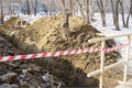 Earthworks.Dug trench and fence tape. Royalty Free Stock Photo