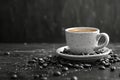 an eary cup of coffee surrounded by coffee beans and beans, in the style of mist, rustic texture, rustic simplicity