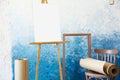 Easel background with a white sheet and a roll of paper