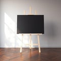 Easel and blank black canvas in bright interior. 3d rendering Royalty Free Stock Photo