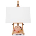 Easel with blank canvas palette paint and brushes Royalty Free Stock Photo