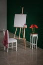 Easel with canvas and chair in artist's workshop Royalty Free Stock Photo