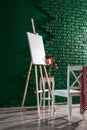 Easel with canvas and chair in artist\'s workshop Royalty Free Stock Photo