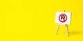 Easel with no turning back traffic sign on a yellow background. Assertiveness and striving, moving forward without retreating.