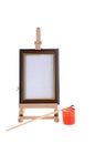 Easel, paint and small brush Royalty Free Stock Photo