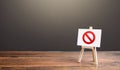 Easel with the prohibition sign NO. Restricted area. Restrictions and sanctions. Inaccessibility. Blocking. Out of stock. Ban and