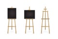 Easel standing with black board or canvas set. Blank blackboard on wooden tripod for art, painting, drawing or Royalty Free Stock Photo