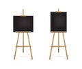 Easel standing with black boards set. Blank blackboard on wooden tripod for art, painting, drawing or announcement Royalty Free Stock Photo