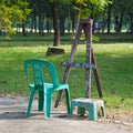 An easel with two plasstic chairs