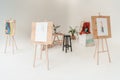 easels with paintings in empty