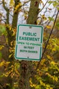 Easement sign to notify public fishing is allowed. Royalty Free Stock Photo