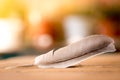 Easiness: Feather on a wooden desk, copy space