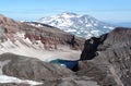 The east crater of Gorely volcano with blue acid lake covered partially with ice in august Royalty Free Stock Photo