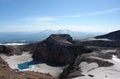 The east crater of Gorely volcano, surrounded by steep two hundred meters rocks with blue acid lake Royalty Free Stock Photo