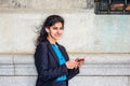 East Indian American college student texting outside in New York Royalty Free Stock Photo