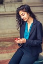 East Indian American college student texting outside in New York Royalty Free Stock Photo