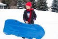 East Indian boy toboganning in the snow Royalty Free Stock Photo