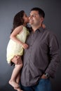 An East Indian girl kisses her father