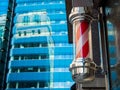 An East London barber shop pole in red & white spiral stripes.