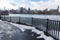 East River Riverfront in Astoria Queens New York Covered with Snow during the Winter with a View of the Roosevelt Island and Manha Royalty Free Stock Photo
