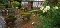 Garden with Greenhouse chairs and table, stone platers and flowers